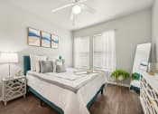 Thumbnail 10 of 53 - a bedroom with a large bed and a ceiling fan