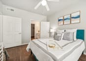 Thumbnail 12 of 53 - a bedroom with a large bed and a ceiling fan
