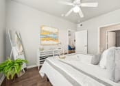 Thumbnail 11 of 53 - a bedroom with a large bed and a ceiling fan