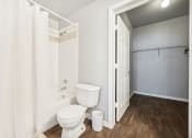 Thumbnail 14 of 53 - a bathroom with a toilet and a shower with a curtain