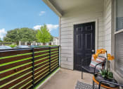 Thumbnail 18 of 53 - a balcony with a black door and a chair on it