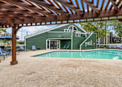 Thumbnail 10 of 18 - a green building with a pool in front of it