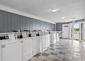 Thumbnail 15 of 18 - a row of washers and dryers in a laundromat