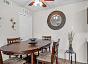 Thumbnail 5 of 18 - a dining room with a table and chairs