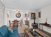 Thumbnail 3 of 18 - a living room with a couch a table and a ceiling fan