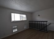 Thumbnail 18 of 18 - an empty living room with a staircase and a window