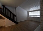 Thumbnail 12 of 18 - an empty living room with a staircase and a window