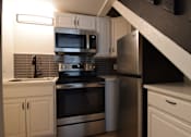 Thumbnail 10 of 18 - a kitchen with stainless steel appliances and white cabinets