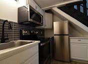 Thumbnail 9 of 18 - a kitchen with a sink and a refrigerator