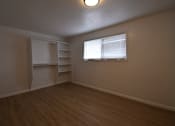 Thumbnail 13 of 18 - an empty living room with a window and shelves