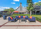 Thumbnail 36 of 52 - a patio with couches and a table in front of a house