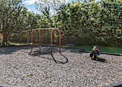 Thumbnail 37 of 52 - a playground with a swing set and a fire hydrant