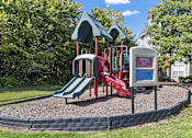 Thumbnail 51 of 52 - a playground with a red slide and a blue and red