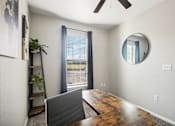 Thumbnail 7 of 36 - a dining room with a large window and a desk with a laptop