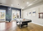 Thumbnail 18 of 36 - a game room with a pool table and a window