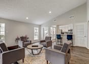 Thumbnail 11 of 21 - a living room with couches and chairs and a table