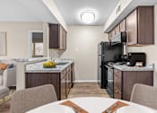 Thumbnail 4 of 37 - our apartments have a kitchen and dining room with a table and chairs