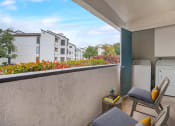 Thumbnail 10 of 11 - a balcony with two chairs and a table and a washing machine
