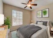 Thumbnail 9 of 42 - a bedroom with a large bed and a ceiling fan