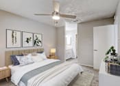 Thumbnail 4 of 21 - our apartments offer a bedroom with a large bed and a ceiling fan