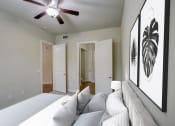 Thumbnail 11 of 36 - a bedroom with a large bed and a ceiling fan
