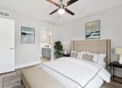 Thumbnail 15 of 41 - a bedroom with a bed and a ceiling fan