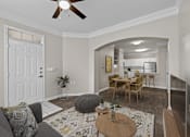 Thumbnail 14 of 52 - A living room with a grey couch and a wooden coffee table.