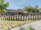 Thumbnail 32 of 33 - a view of the front of the building with a fence in the foreground and a building in