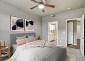 Thumbnail 10 of 33 - a bedroom with a large bed and a ceiling fan