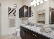 Thumbnail 10 of 28 - a bathroom with a sink and a toilet and a mirror