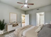 Thumbnail 6 of 33 - a bedroom with a large bed and a ceiling fan