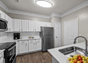 Thumbnail 17 of 52 - a kitchen with white cabinets and stainless steel appliances