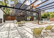 Thumbnail 29 of 33 - a patio with a pool and lounge chairs and a ceiling fan