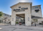 Thumbnail 12 of 36 - the facade of heritage village residences with a gate