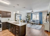 Thumbnail 4 of 36 - the view of a kitchen and living room with a large window