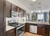 Thumbnail 3 of 36 - an updated kitchen with stainless steel appliances and wooden cabinets