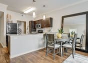 Thumbnail 5 of 36 - an open kitchen and dining area with a table and chairs