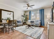 Thumbnail 1 of 36 - a living room with a couch and a dining room table