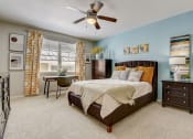 Thumbnail 7 of 36 - a bedroom with a bed and a ceiling fan