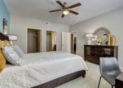 Thumbnail 8 of 36 - a bedroom with a large bed and a ceiling fan