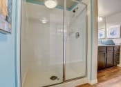 Thumbnail 10 of 36 - a shower with a glass door in a bathroom