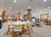 Thumbnail 14 of 36 - a large room with tables and chairs in a lobby