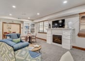 Thumbnail 16 of 36 - a living room with a fireplace and a tv