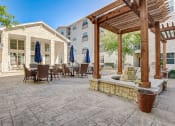 Thumbnail 28 of 36 - a patio with tables and chairs and a pergola