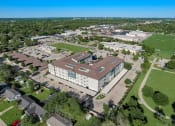 Thumbnail 34 of 36 - an aerial view of a campus with a building and a field