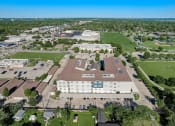 Thumbnail 33 of 36 - an aerial view of a campus with a field and buildings