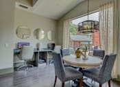 Thumbnail 20 of 34 - a dining area with a table and chairs and a large window