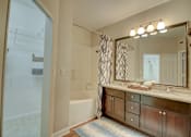 Thumbnail 9 of 34 - a bathroom with a large mirror and a bathtub