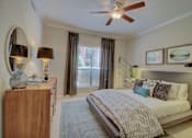 Thumbnail 7 of 34 - a bedroom with a ceiling fan and a large window