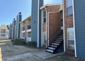 Thumbnail 26 of 29 - an exterior view of a brick apartment building with stairs